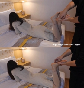 Ticking Chinese girl's beautiful feet on bed